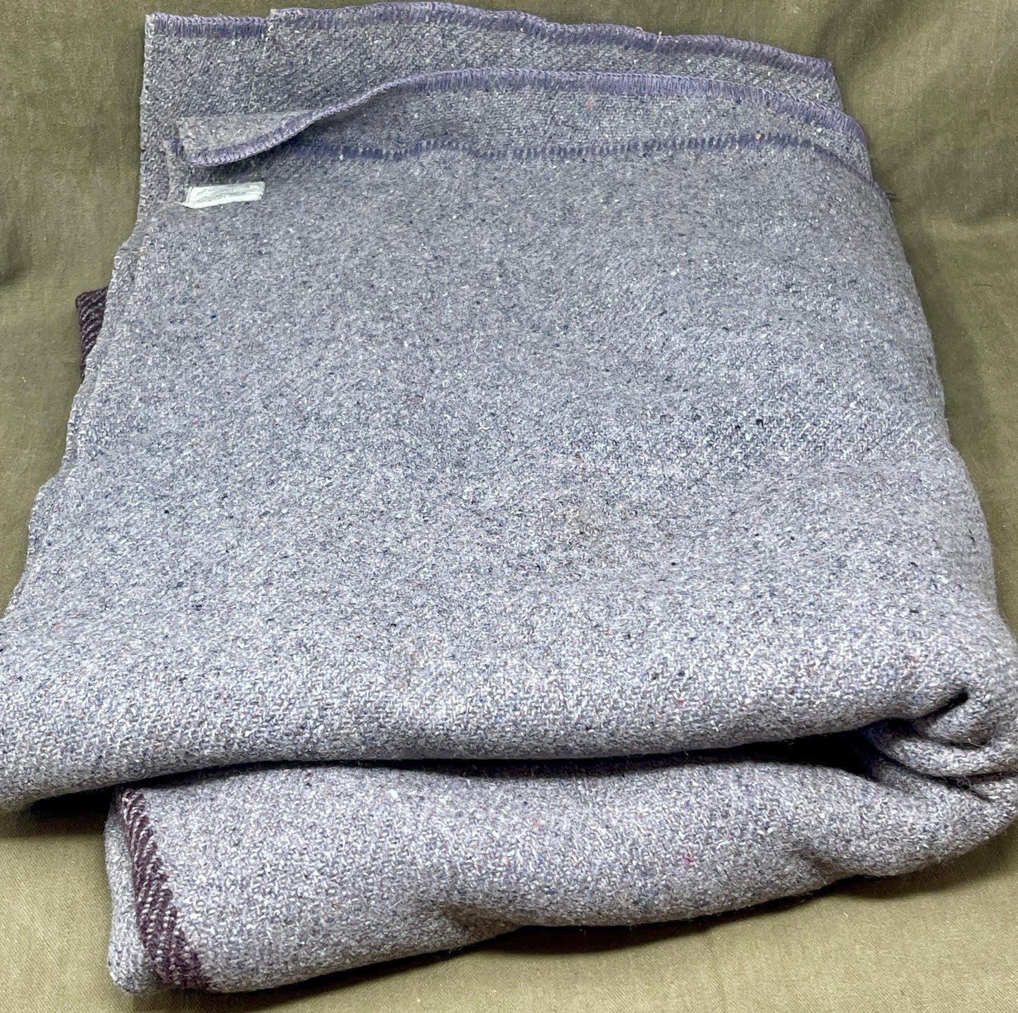 Folded gray garment on a beige surface
