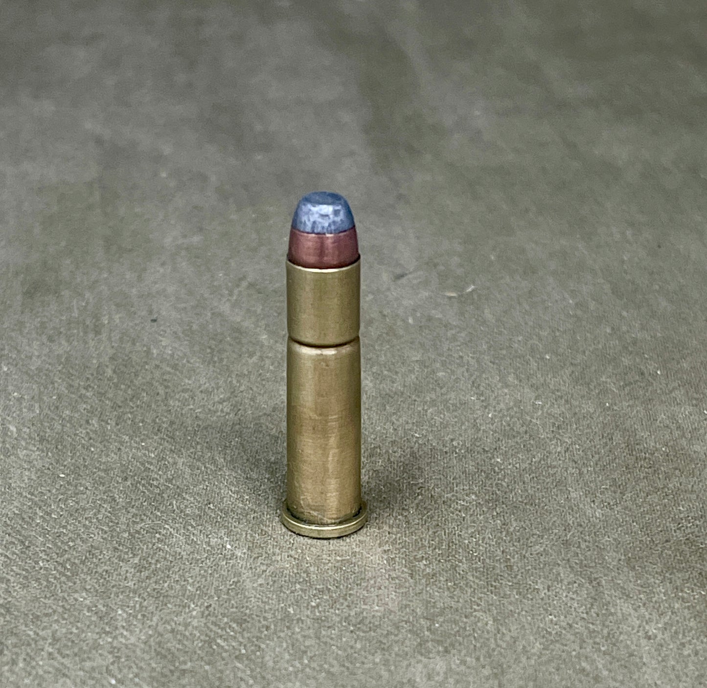 Bullet casing on a textured gray surface