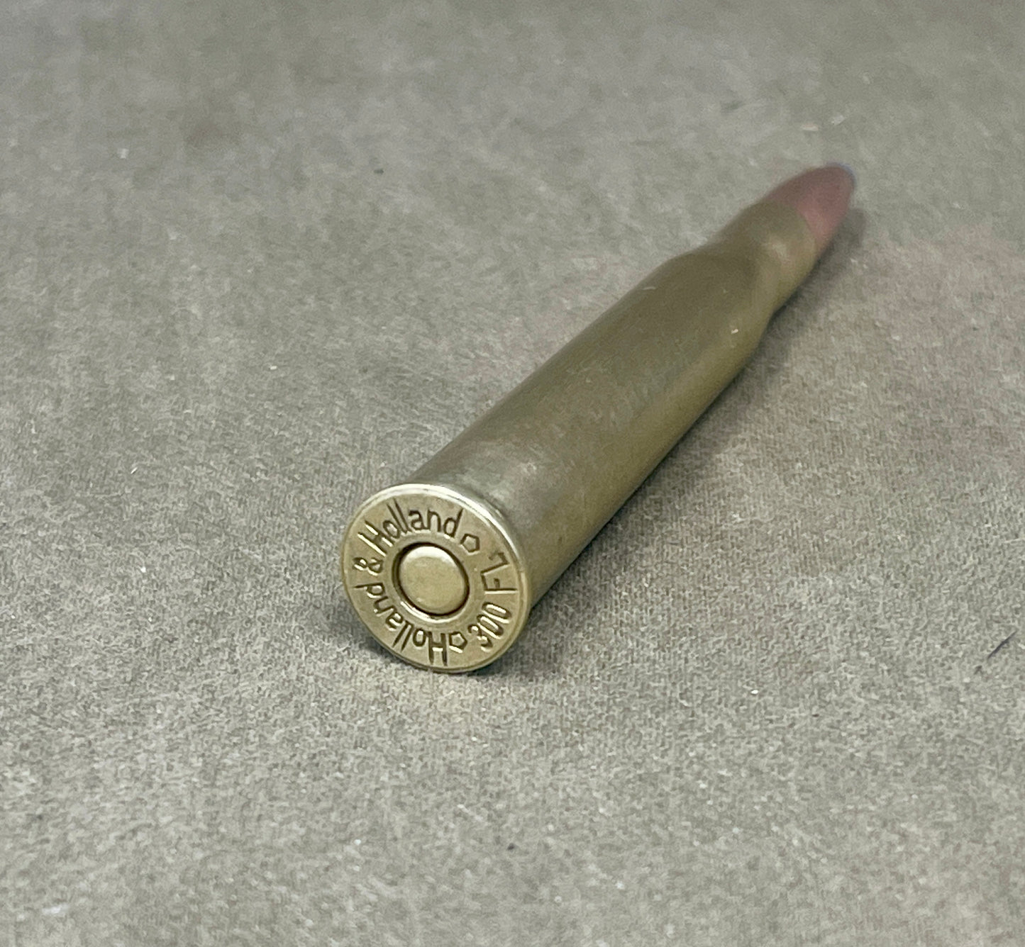 Bullet with 'Holland & Holland' branding on a gray surface