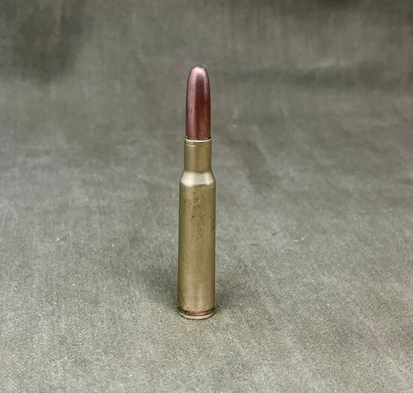 Bullet casing on a textured gray background