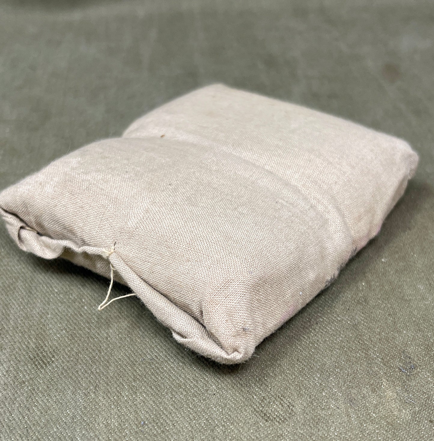 Two gray fabric bags on a textured gray surface