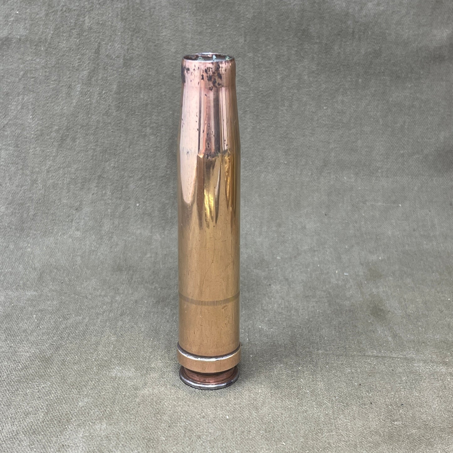 The 3.7cm Flak 18 shell casing, dating back to 1940, was a key component of Germany's anti-aircraft arsenal during World War II. The Flak 18 was a 3.7 cm anti-aircraft cannon designed to target enemy aircraft, with its shells capable of reaching high altitudes with precision. Each shell consisted of a high-explosive projectile and a brass casing marked with details such as the manufacturing date, place of production, and type of round. The 3.7cm rounds were approximately 37x263B in size, with the "B" denot