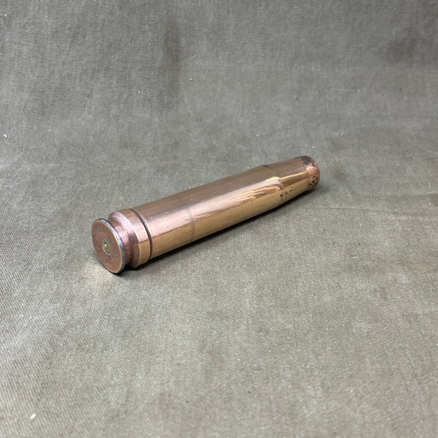 The 3.7cm Flak 18 shell casing, dating back to 1940, was a key component of Germany's anti-aircraft arsenal during World War II. The Flak 18 was a 3.7 cm anti-aircraft cannon designed to target enemy aircraft, with its shells capable of reaching high altitudes with precision. Each shell consisted of a high-explosive projectile and a brass casing marked with details such as the manufacturing date, place of production, and type of round. The 3.7cm rounds were approximately 37x263B in size, with the "B" denot