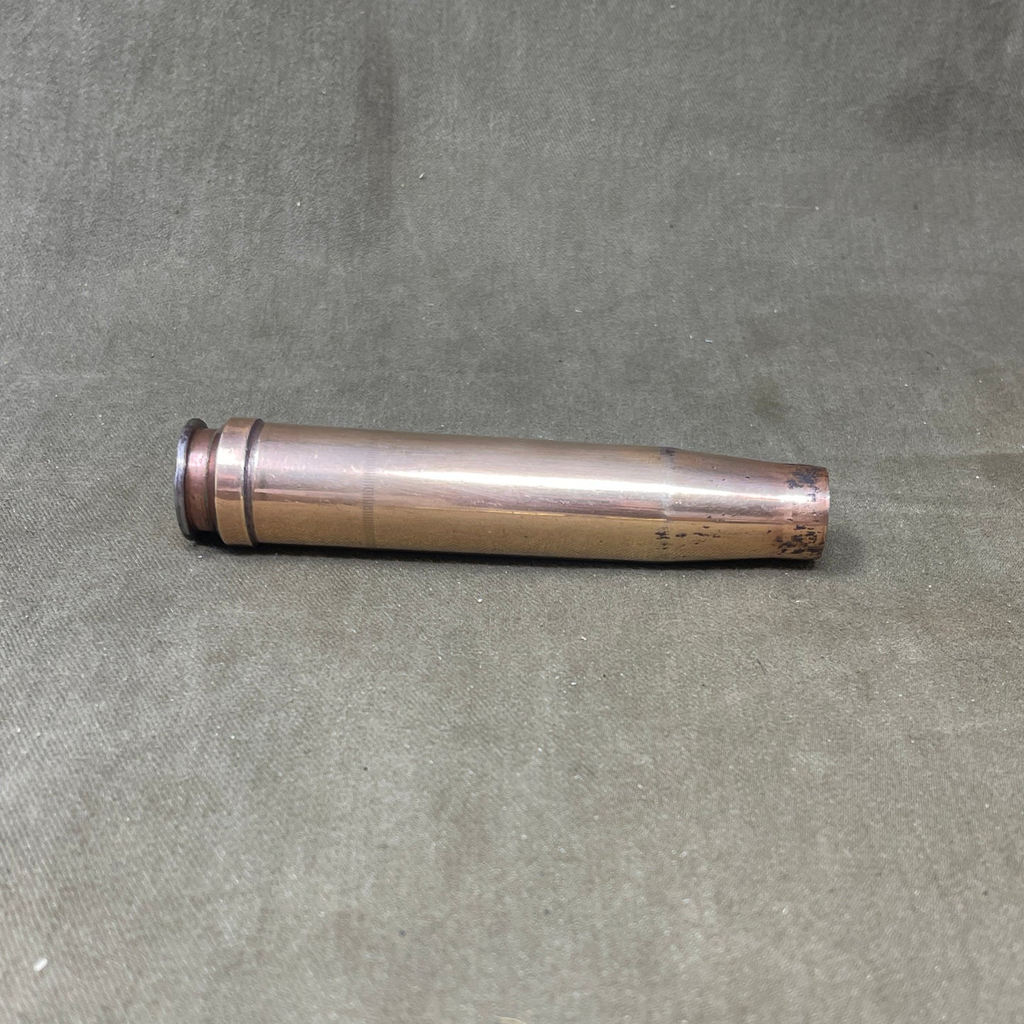 The 3.7cm Flak 18 shell casing, dating back to 1940, was a key component of Germany's anti-aircraft arsenal during World War II. The Flak 18 was a 3.7 cm anti-aircraft cannon designed to target enemy aircraft, with its shells capable of reaching high altitudes with precision. Each shell consisted of a high-explosive projectile and a brass casing marked with details such as the manufacturing date, place of production, and type of round. The 3.7cm rounds were approximately 37x263B in size, with the "B" denot