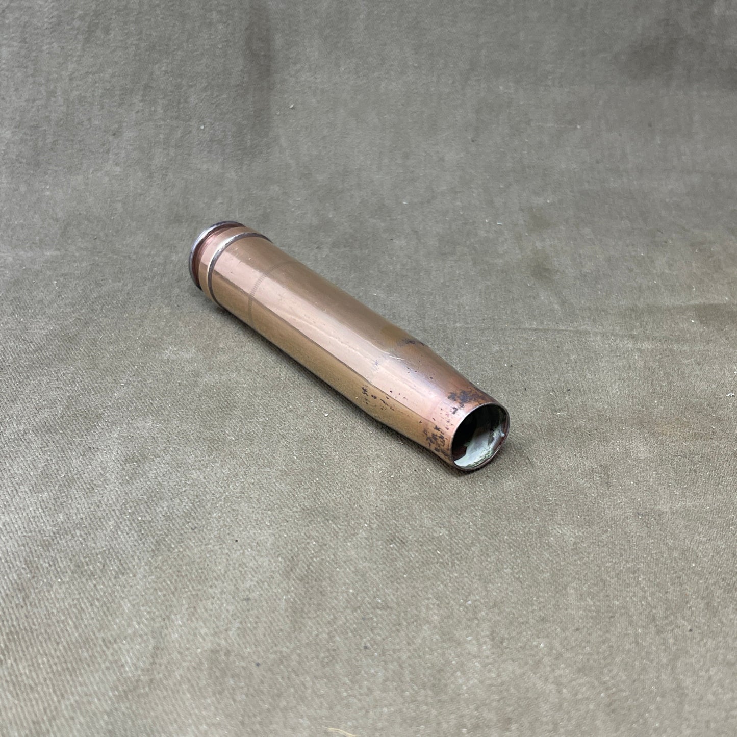 The 3.7cm Flak 18 shell casing, dating back to 1940, was a key component of Germany's anti-aircraft arsenal during World War II. The Flak 18 was a 3.7 cm anti-aircraft cannon designed to target enemy aircraft, with its shells capable of reaching high altitudes with precision. Each shell consisted of a high-explosive projectile and a brass casing marked with details such as the manufacturing date, place of production, and type of round. The 3.7cm rounds were approximately 37x263B in size, with the "B" denot