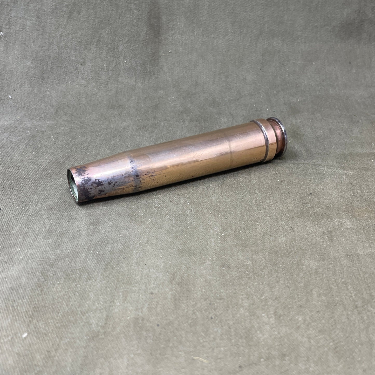 The 3.7cm Flak 18 shell casing, dating back to 1940, was a key component of Germany's anti-aircraft arsenal during World War II. The Flak 18 was a 3.7 cm anti-aircraft cannon designed to target enemy aircraft, with its shells capable of reaching high altitudes with precision. Each shell consisted of a high-explosive projectile and a brass casing marked with details such as the manufacturing date, place of production, and type of round. The 3.7cm rounds were approximately 37x263B in size, with the "B" denot