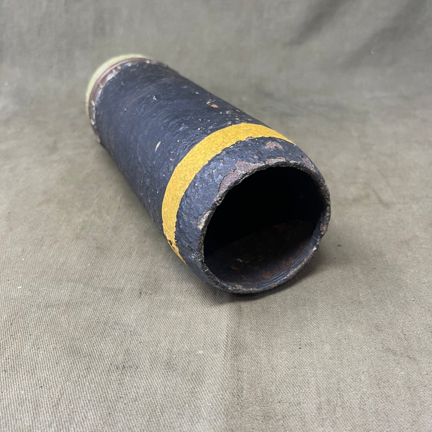 The inert 18-pounder shrapnel round was a crucial munition for the British QF (Quick Firing) 18-pounder field gun, extensively used during World War I. Designed primarily to counter infantry and soft targets, this round featured a cylindrical shell packed with hundreds of lead or steel balls, propelled by a timed fuse. Upon reaching a pre-set point in its trajectory, the fuse ignited a small bursting charge, scattering the shrapnel balls over a wide area, effectively creating a deadly hail of projectiles.