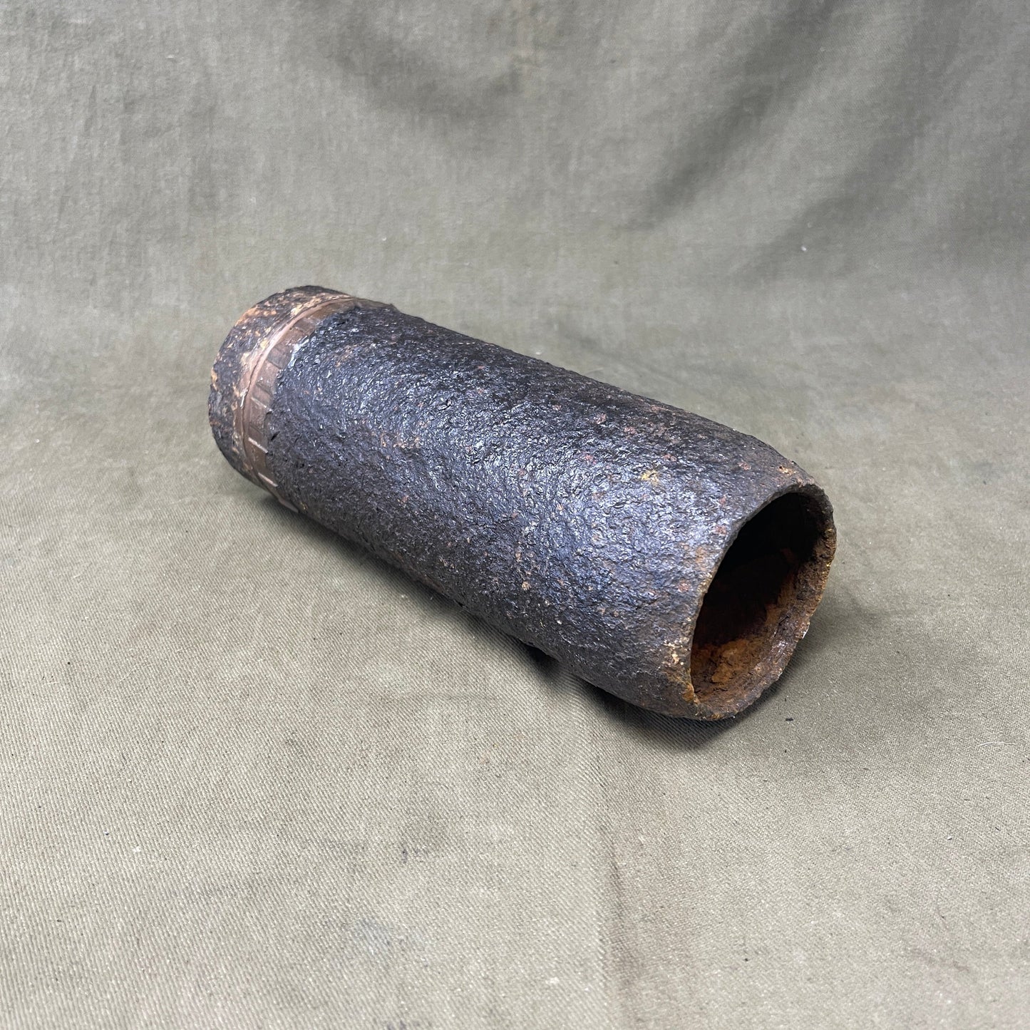 The inert 18-pounder shrapnel round was a crucial munition for the British QF (Quick Firing) 18-pounder field gun, extensively used during World War I. Designed primarily to counter infantry and soft targets, this round featured a cylindrical shell packed with hundreds of lead or steel balls, propelled by a timed fuse. Upon reaching a pre-set point in its trajectory, the fuse ignited a small bursting charge, scattering the shrapnel balls over a wide area, effectively creating a deadly hail of projectiles.