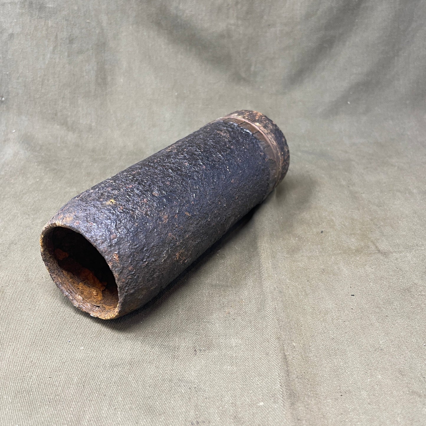 The inert 18-pounder shrapnel round was a crucial munition for the British QF (Quick Firing) 18-pounder field gun, extensively used during World War I. Designed primarily to counter infantry and soft targets, this round featured a cylindrical shell packed with hundreds of lead or steel balls, propelled by a timed fuse. Upon reaching a pre-set point in its trajectory, the fuse ignited a small bursting charge, scattering the shrapnel balls over a wide area, effectively creating a deadly hail of projectiles.