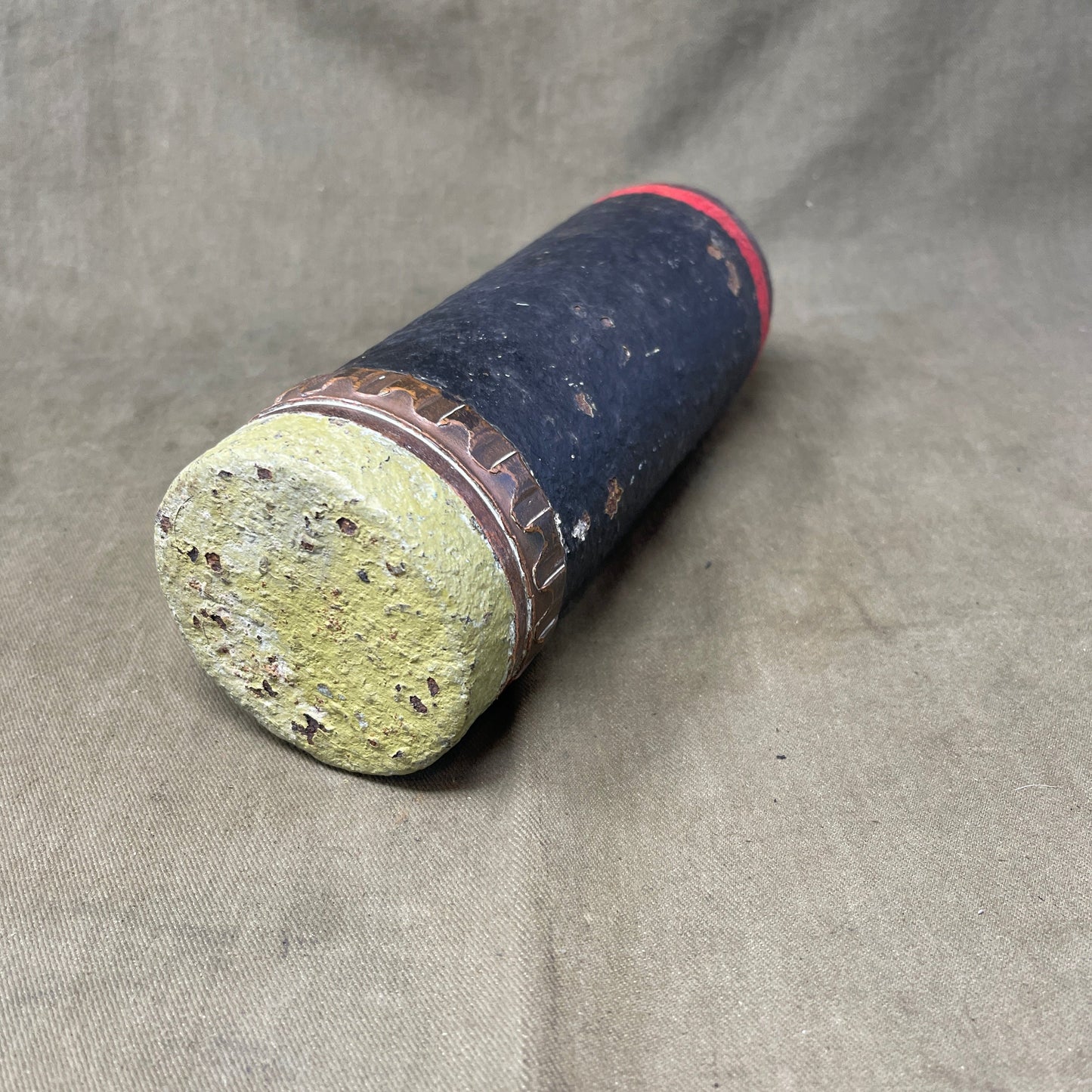 The inert 18-pounder shrapnel round was a crucial munition for the British QF (Quick Firing) 18-pounder field gun, extensively used during World War I. Designed primarily to counter infantry and soft targets, this round featured a cylindrical shell packed with hundreds of lead or steel balls, propelled by a timed fuse. Upon reaching a pre-set point in its trajectory, the fuse ignited a small bursting charge, scattering the shrapnel balls over a wide area, effectively creating a deadly hail of projectiles.