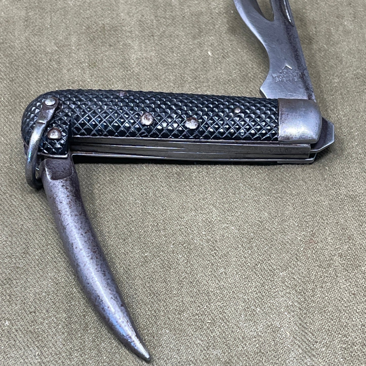 A nice example of a British 1942 Dated Pocket Jack Knife made by Clarke & Son of Sheffield The blades are in good condition, the chequered Bakelite grip is intact and all the blades lock and close as they should. The steel can opener is in good condition