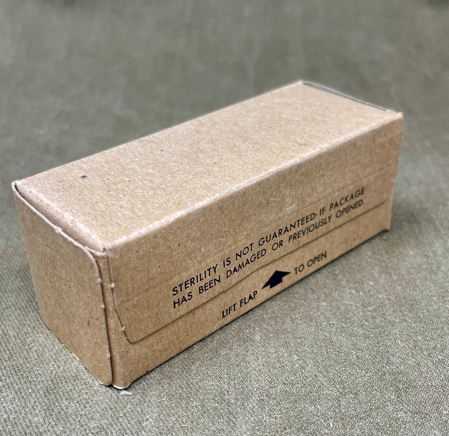 The U.S. Army Bandage, Gauze, Roller, 4 Inch by 10 Yards, Sterile was a military-issue medical supply used for wound dressing and stabilization. Manufactured by Johnson & Johnson under a U.S. government contract in 1960, this sterile gauze bandage was essential for treating injuries in field conditions.
Measuring 4 inches wide and 10 yards long, the bandage was designed for versatility in wound management, allowing medics and soldiers to wrap and secure dressings, control bleeding, and protect wounds from