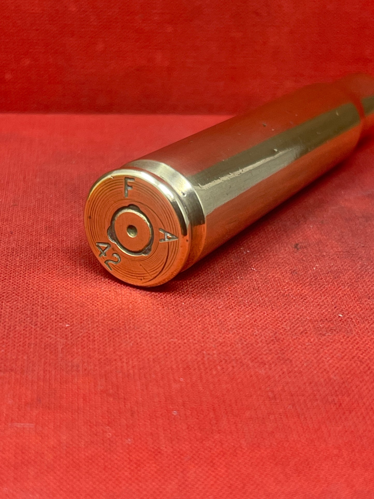 This authentic 1942-dated .50 caliber brass cartridge case, manufactured by Frankford Arsenal (F A) in the USA, is a significant relic from World War II. Originally designed for use in the powerful M2 Browning machine gun, this cartridge case played a crucial role in air, land, and naval combat.
Stamped with the "F A 42" headstamp, this case provides a direct connection to America’s wartime ammunition production, showcasing the craftsmanship and engineering that supported the Allied war effort. The .50 BMG