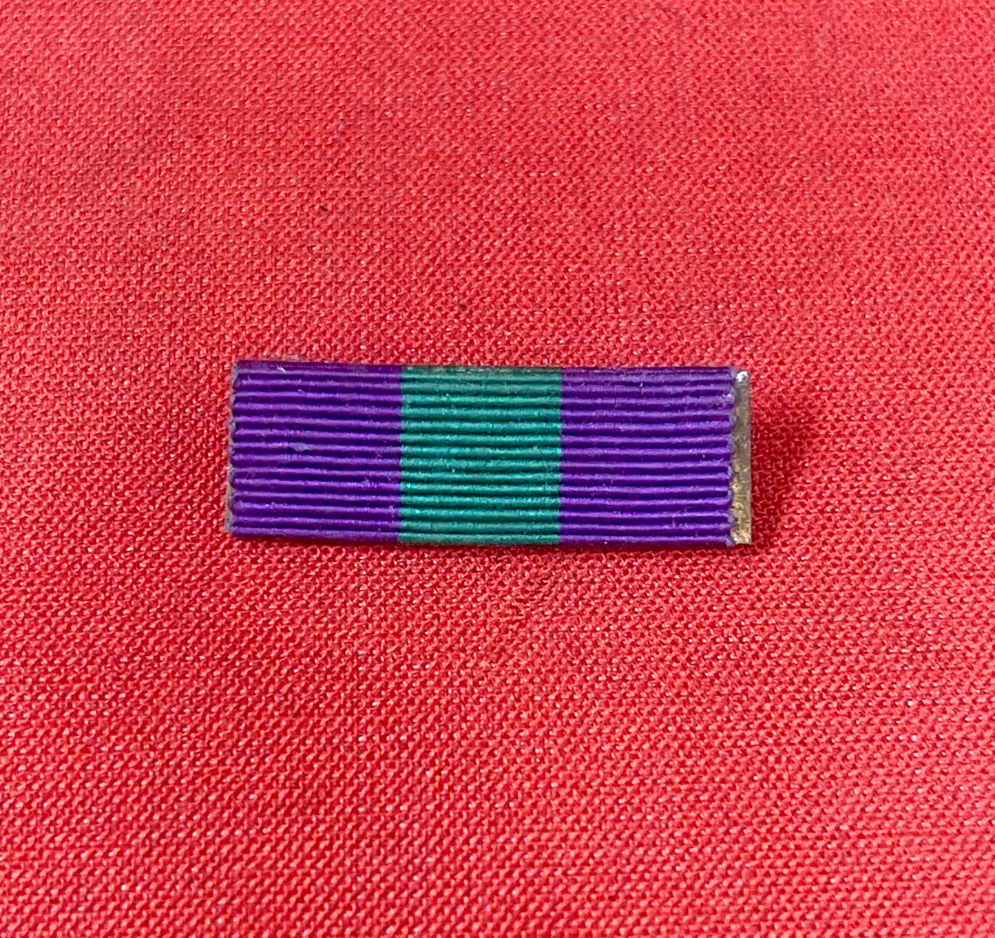 The King George VI General Service Medal (GSM) 1918-1962 ribbon is purple with a central green stripe