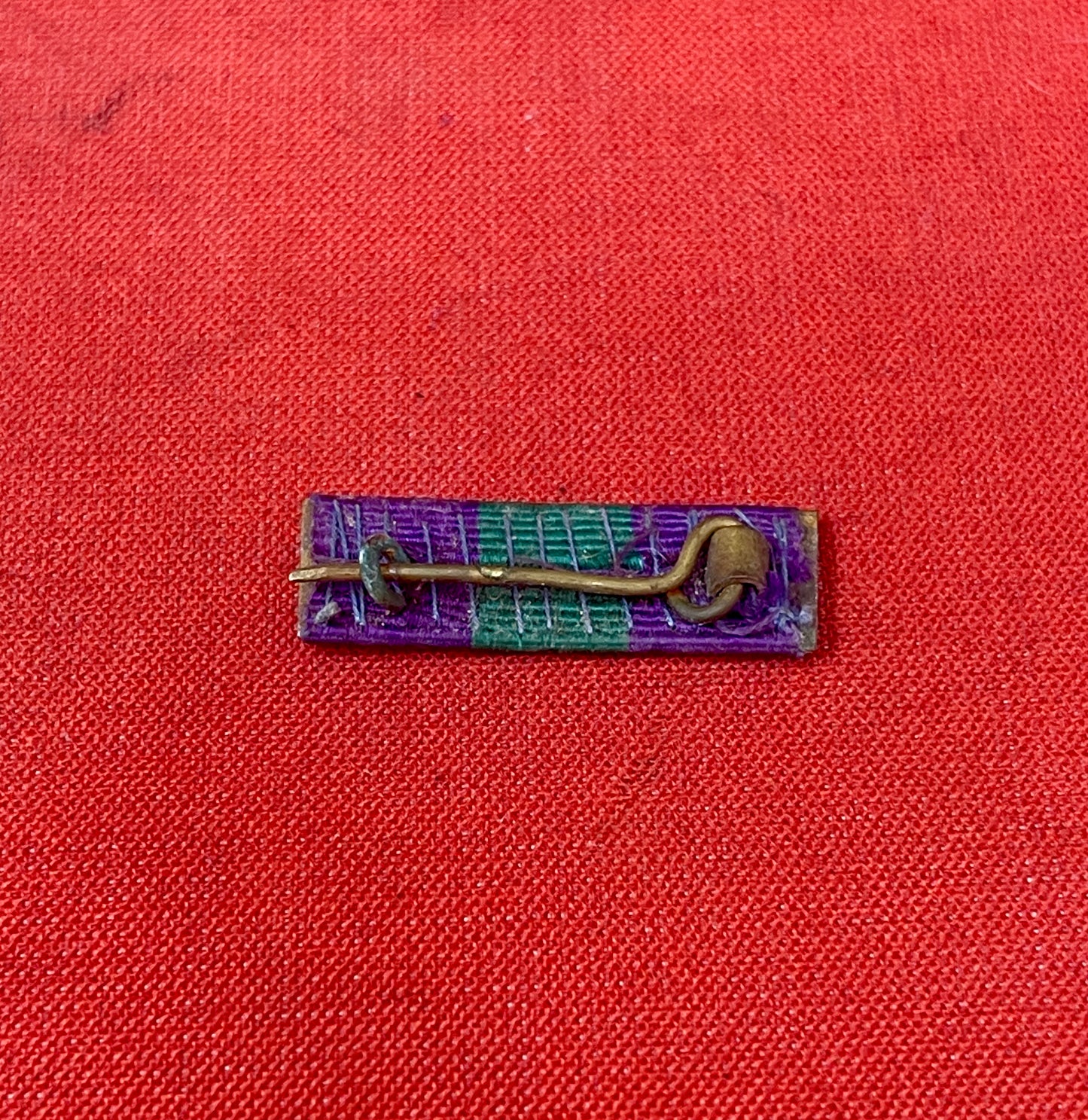 The King George VI General Service Medal (GSM) 1918-1962 ribbon is purple with a central green stripe