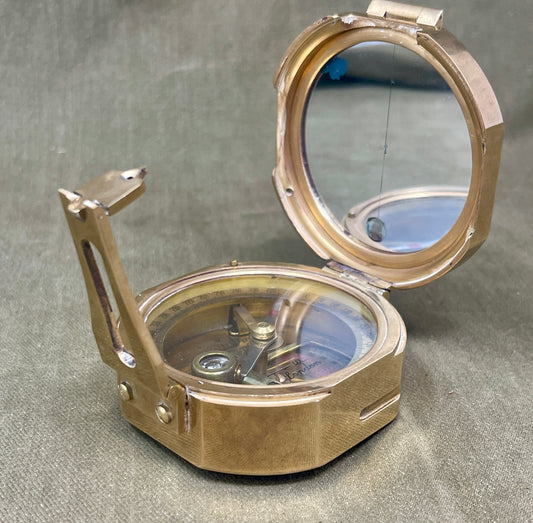 Vintage-style brass compass on a textured surface