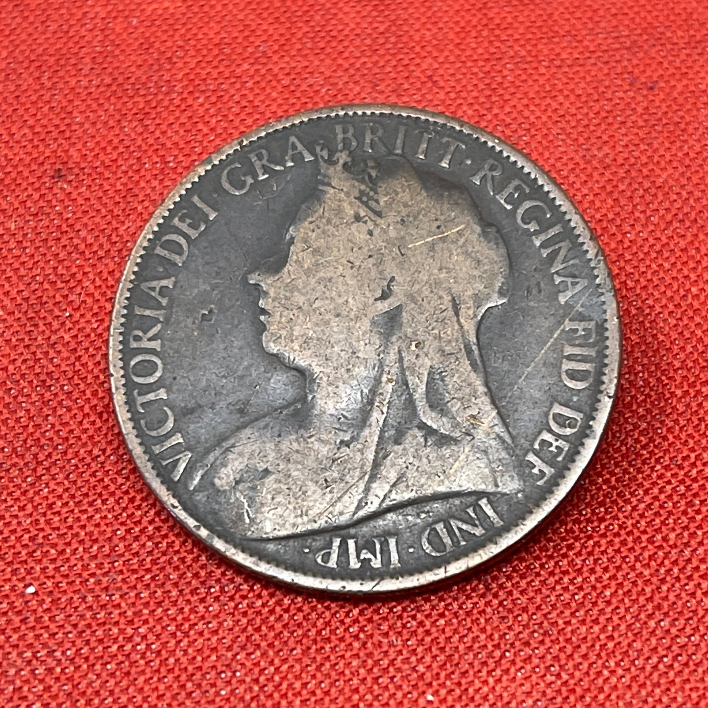 The Queen Victoria One Penny, minted in 1896, features a portrait of Queen Victoria on the obverse side. The monarch's profile is surrounded by inscriptions denoting her name, and title. On the reverse side, you'll typically find the denomination "ONE PENNY" along with a depiction of Britannia, a symbol of British strength and pride. and the year of minting