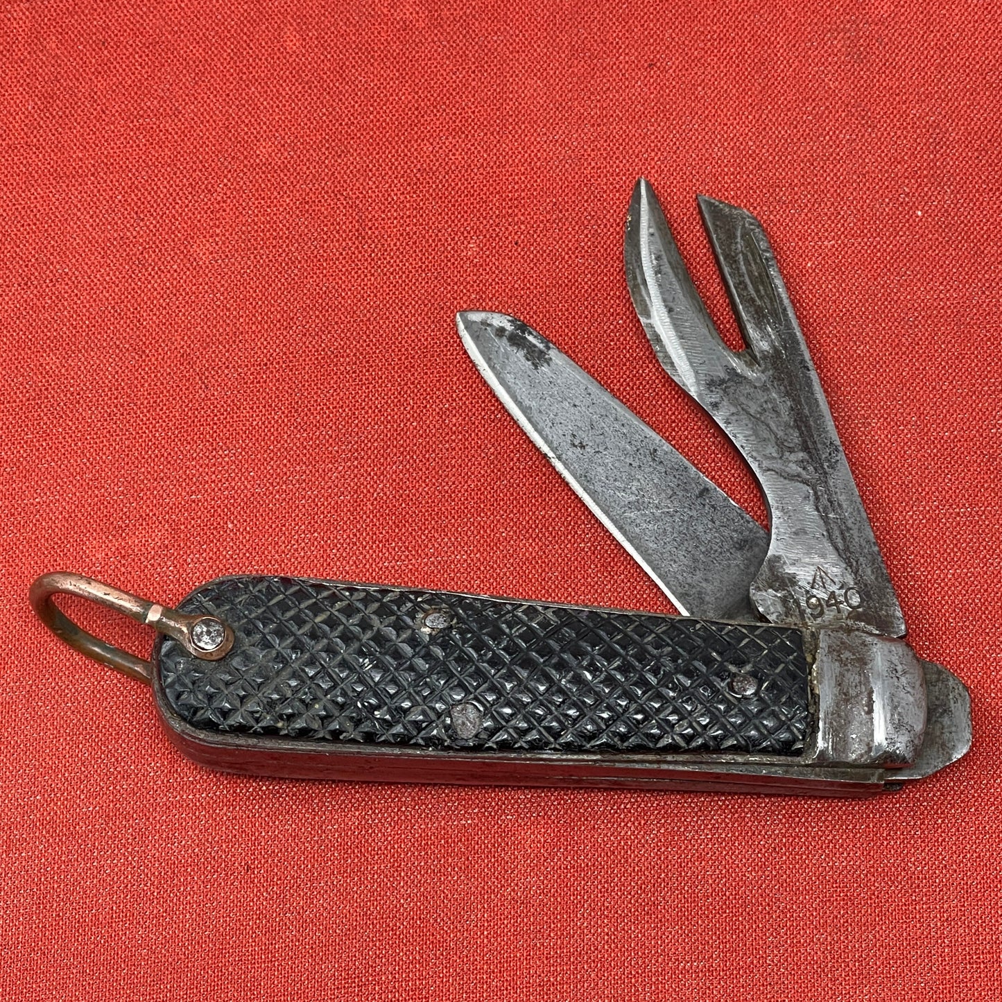 A nice example of a British Jack Knife, dated 1940 The blades are in good condition, the chequered Bakelite grip is intact and all the blades lock and close as they should. The steel can opener is in good condition