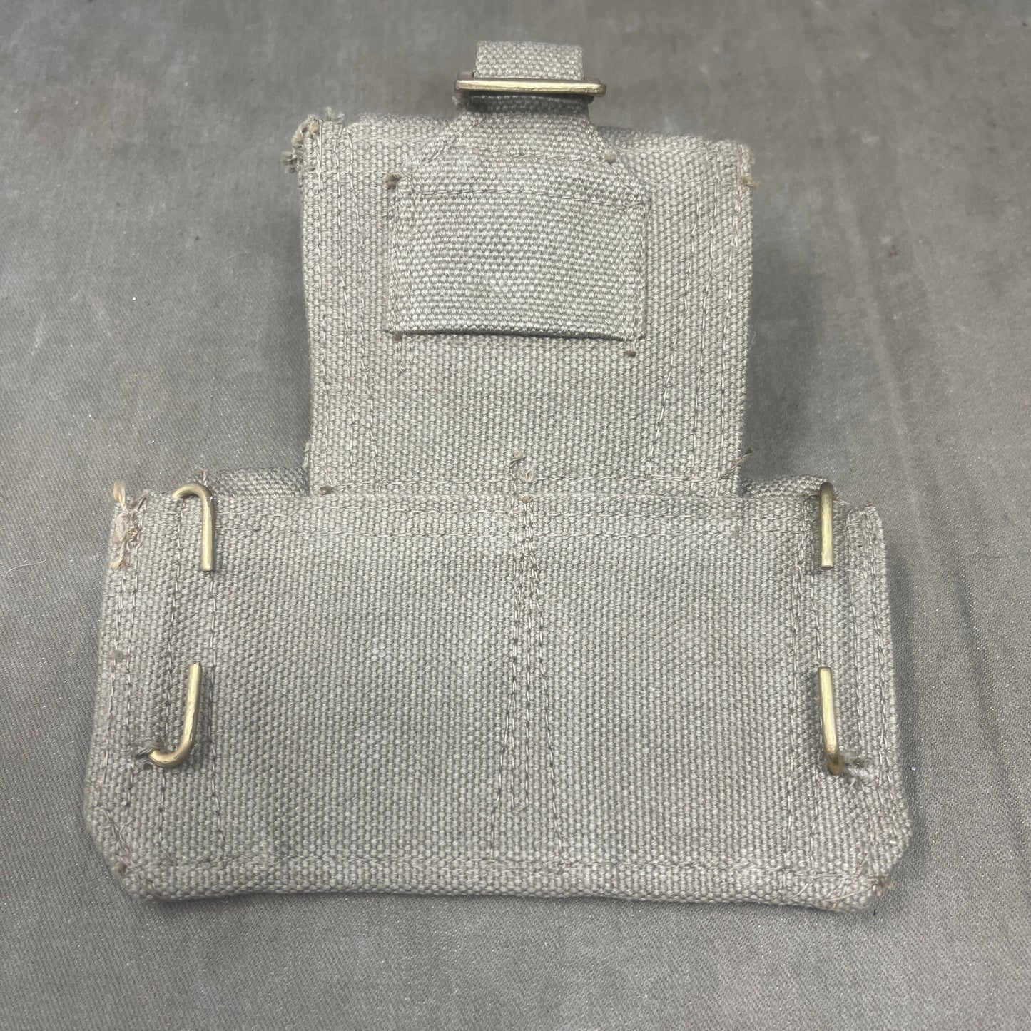 Two metallic chainmail pouches on a gray background
