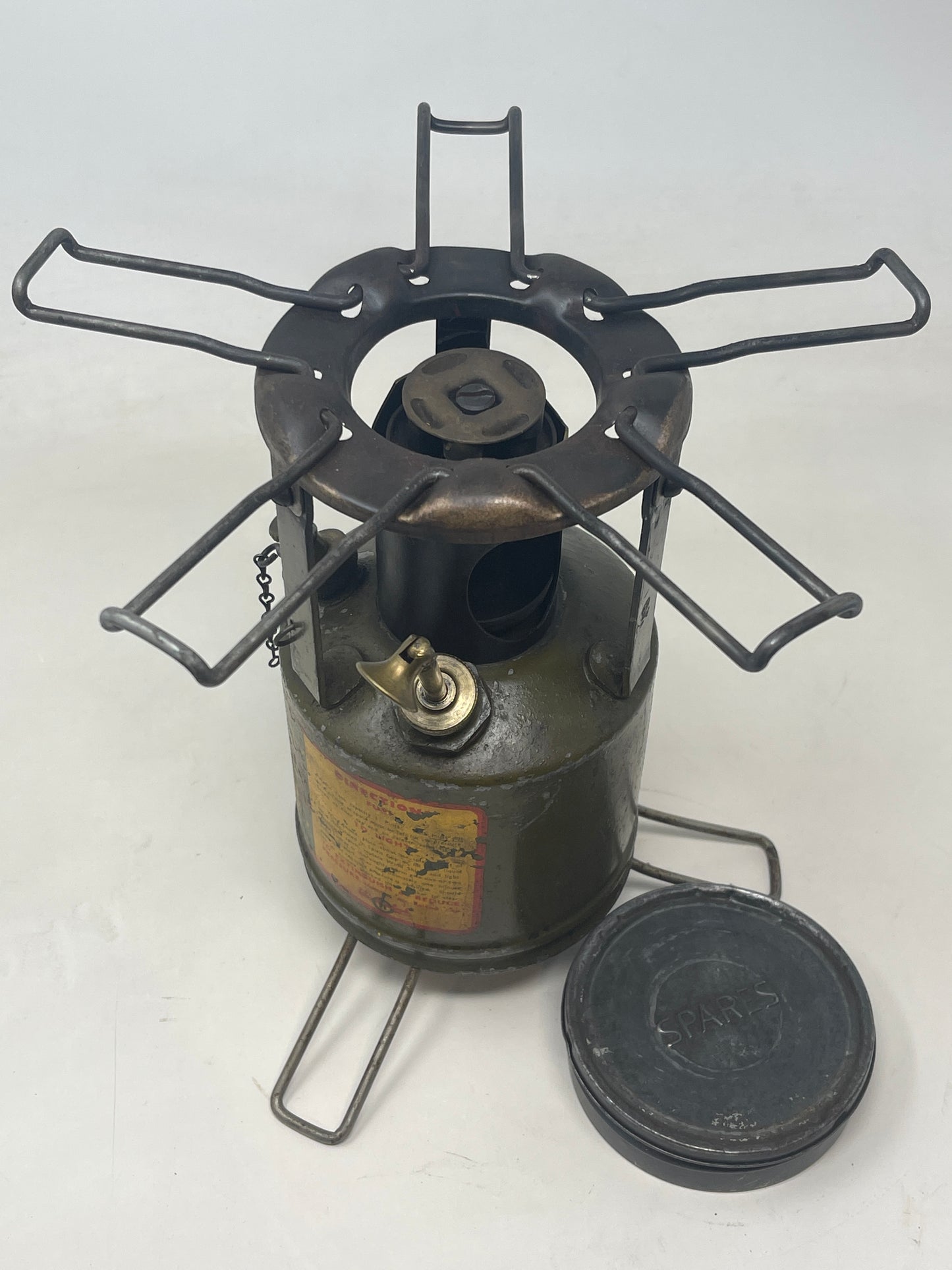 view of to of An original WW2 "Hurlock " field cooker legs and limbs extended spare tin to side