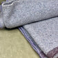 Close-up of textured fabric with a neutral background