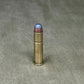 Bullet casing on a textured gray surface