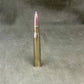 Metallic bullet on a textured gray background