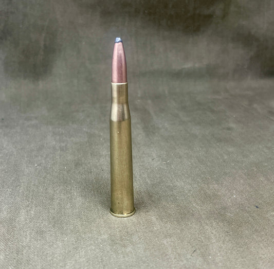Metallic bullet on a textured gray background