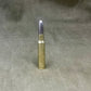 Barely visible bullet casing on a gray fabric background