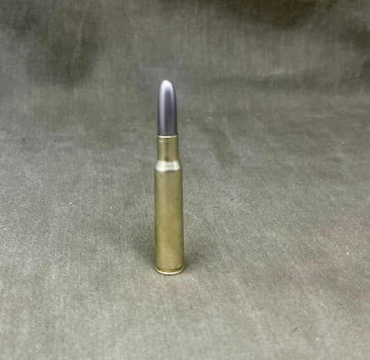 Barely visible bullet casing on a gray fabric background