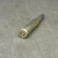Metallic cylindrical object on a gray surface