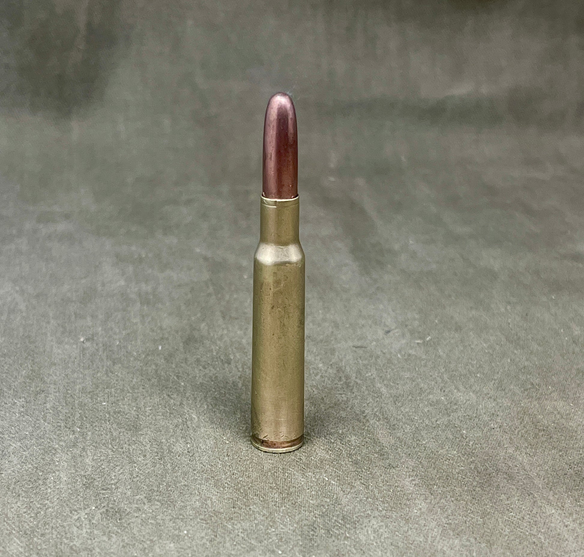 Bullet casing on a textured gray background