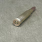Bullseye bullet on a gray concrete surface