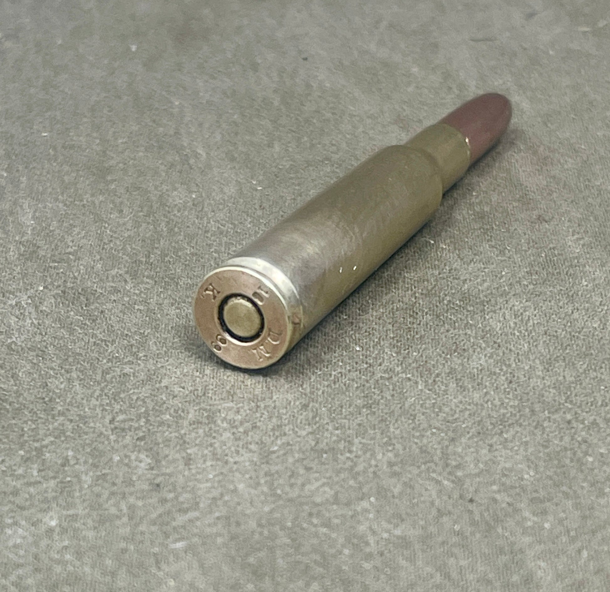 Bullseye bullet on a gray concrete surface