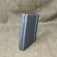 Black rifle magazine on a beige fabric background
