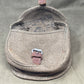 Brown leather saddlebag on a gray surface