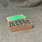 Cardboard box with small bottles on a gray background