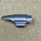Metallic gun part with 'SAV' branding on a beige background