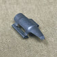 Black plastic component on a beige fabric background