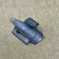 Black plastic clip on a beige textured background