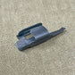 Black plastic component on a beige textured background