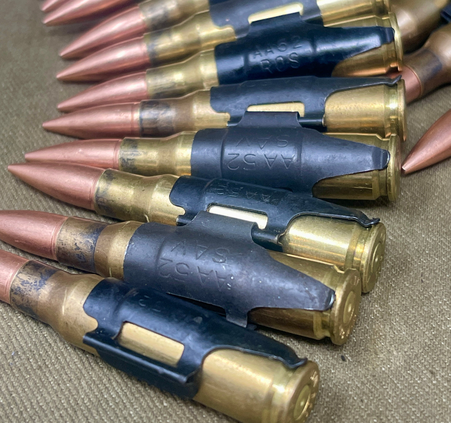 Row of rifle cartridges on a textured surface