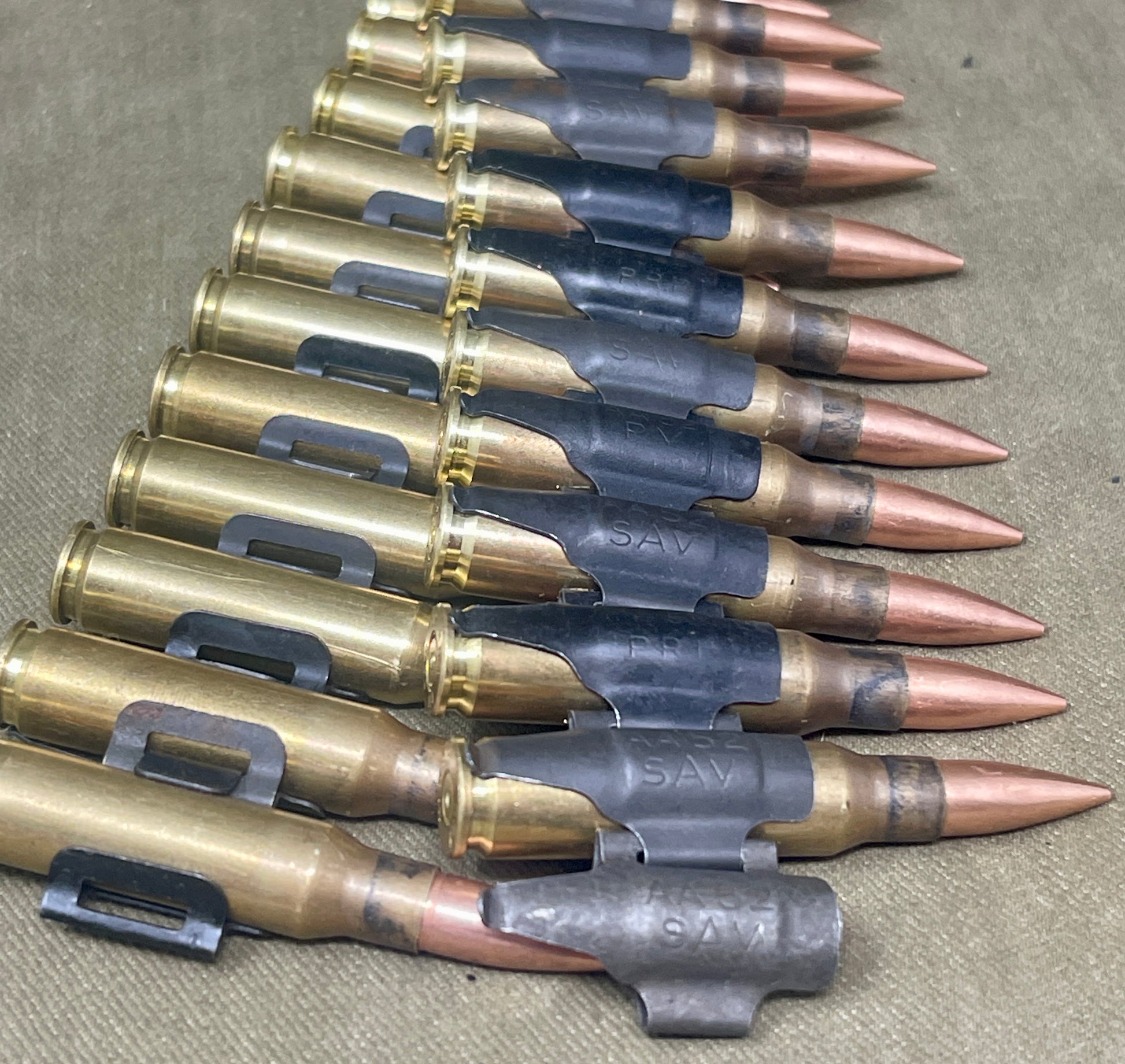 Row of rifle cartridges on a textured surface