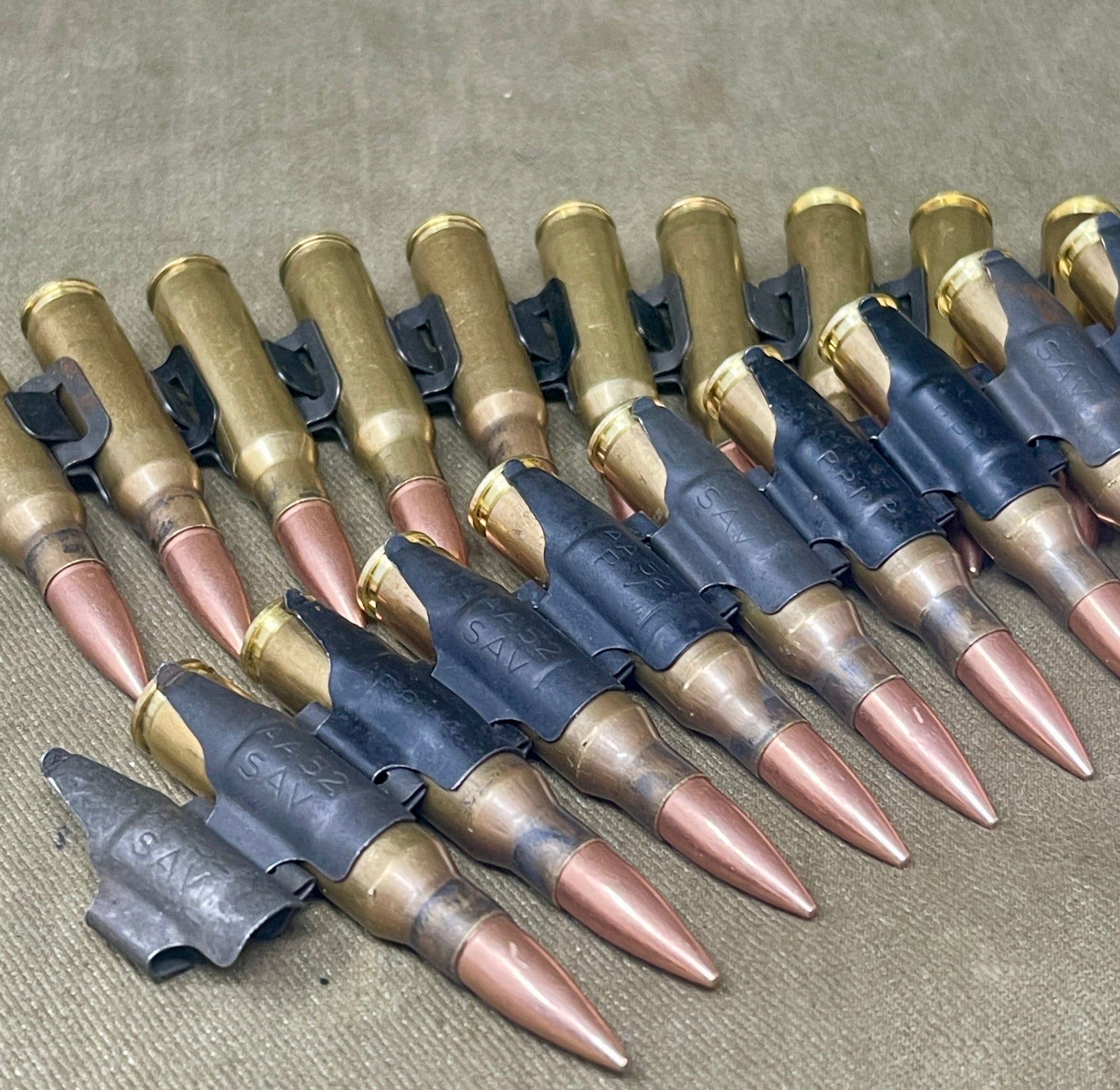 Row of ammunition cartridges on a textured surface