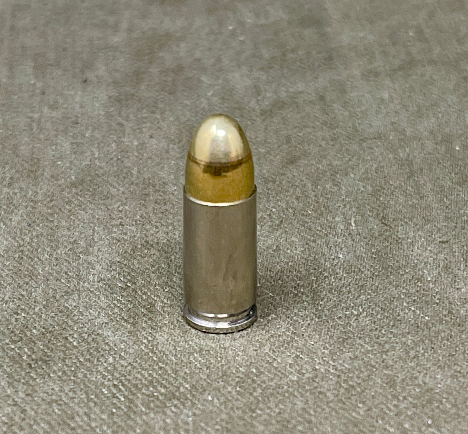 Bullet on a textured gray surface