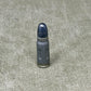 Bullet casing on a textured gray surface