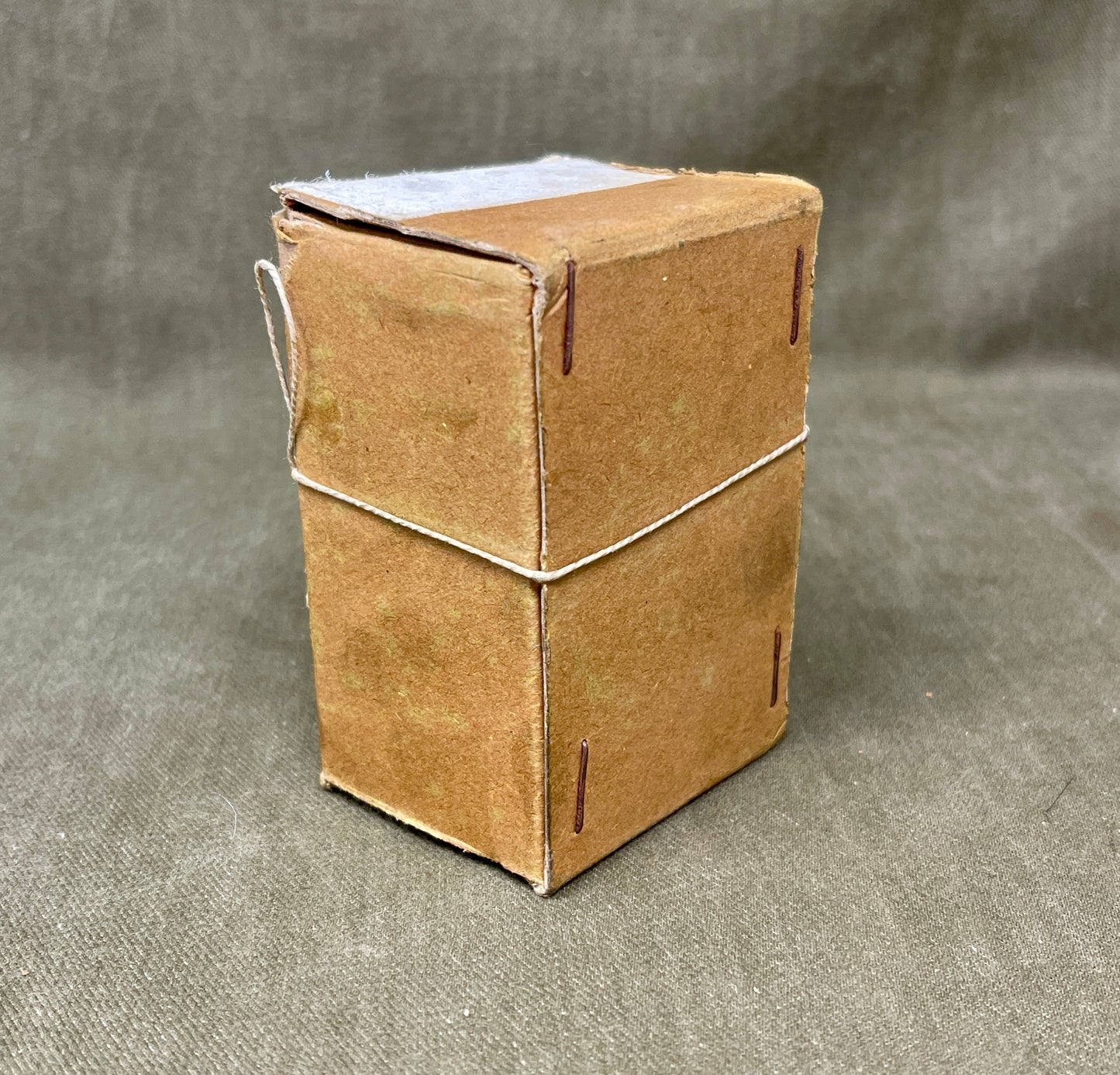 Small cardboard box on a textured gray surface