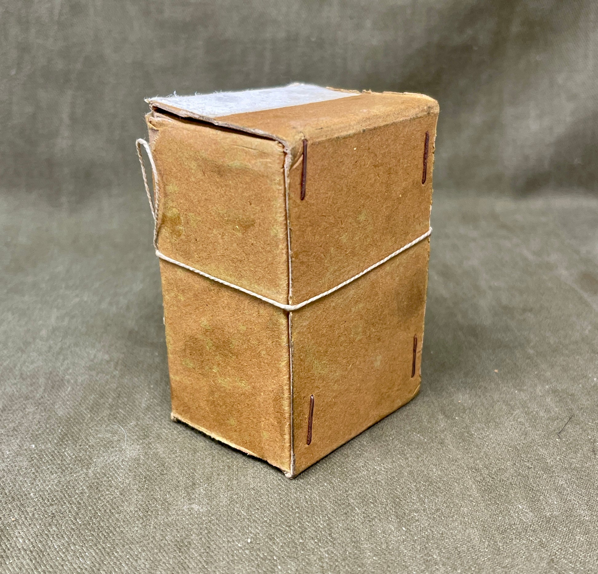 Small cardboard box on a textured gray surface