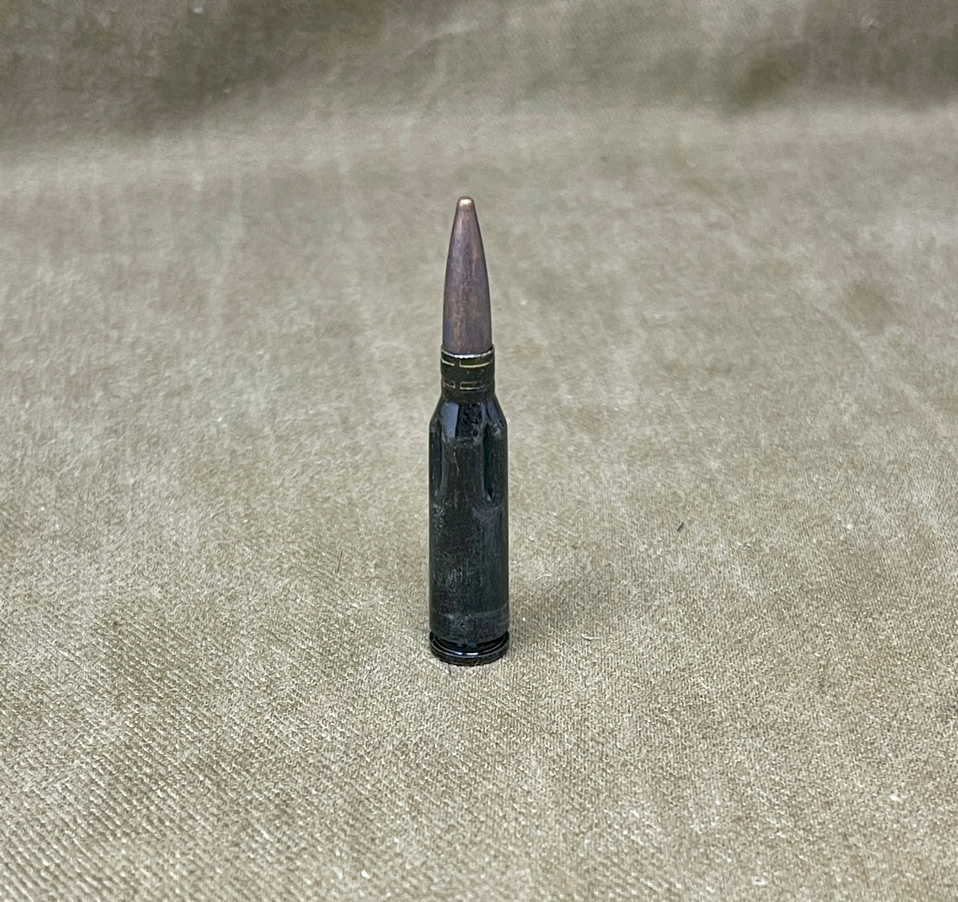 Bullet on a textured beige surface