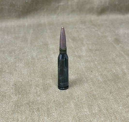 Bullet on a textured beige surface